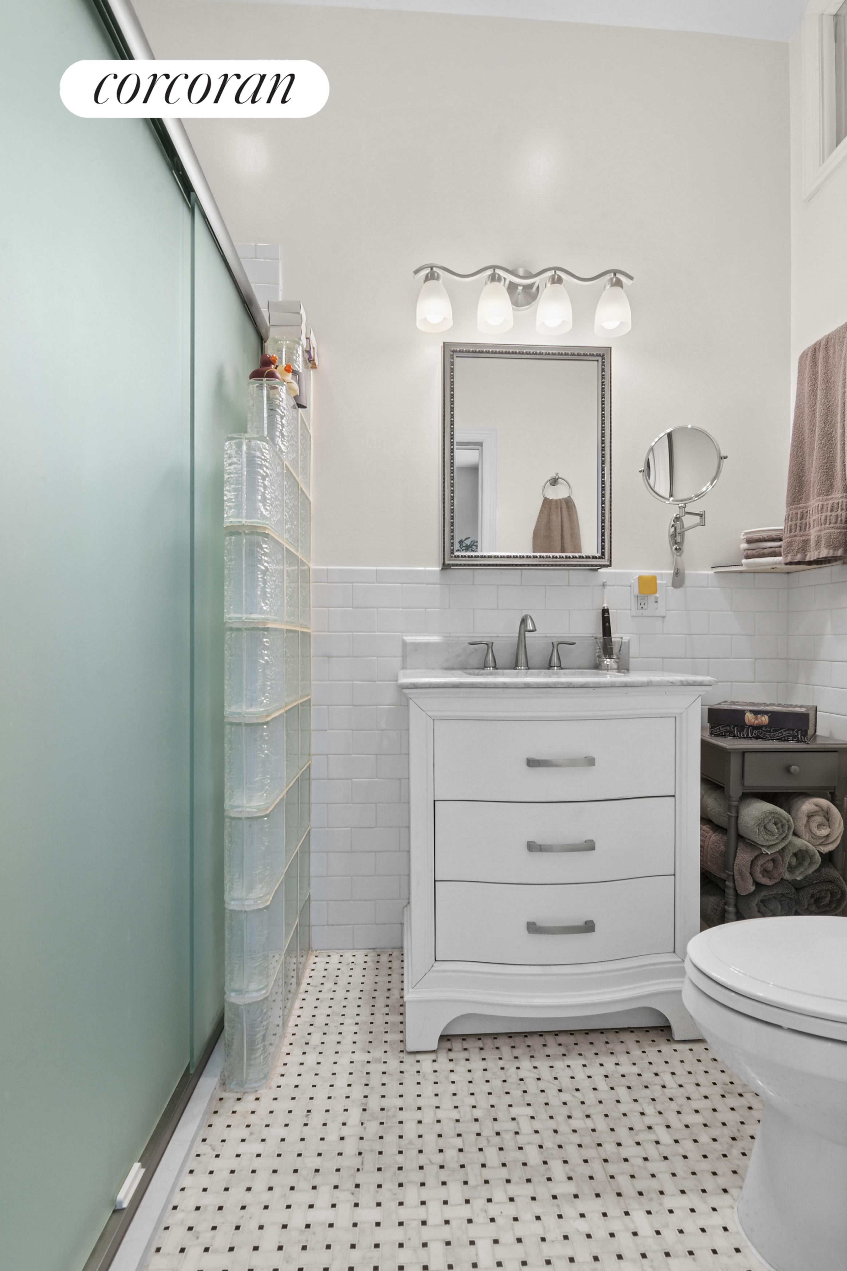 178 Sackett Street Brooklyn, NY 10017 - Photo 6 of 13 a bathroom with a sink a toilet and shower