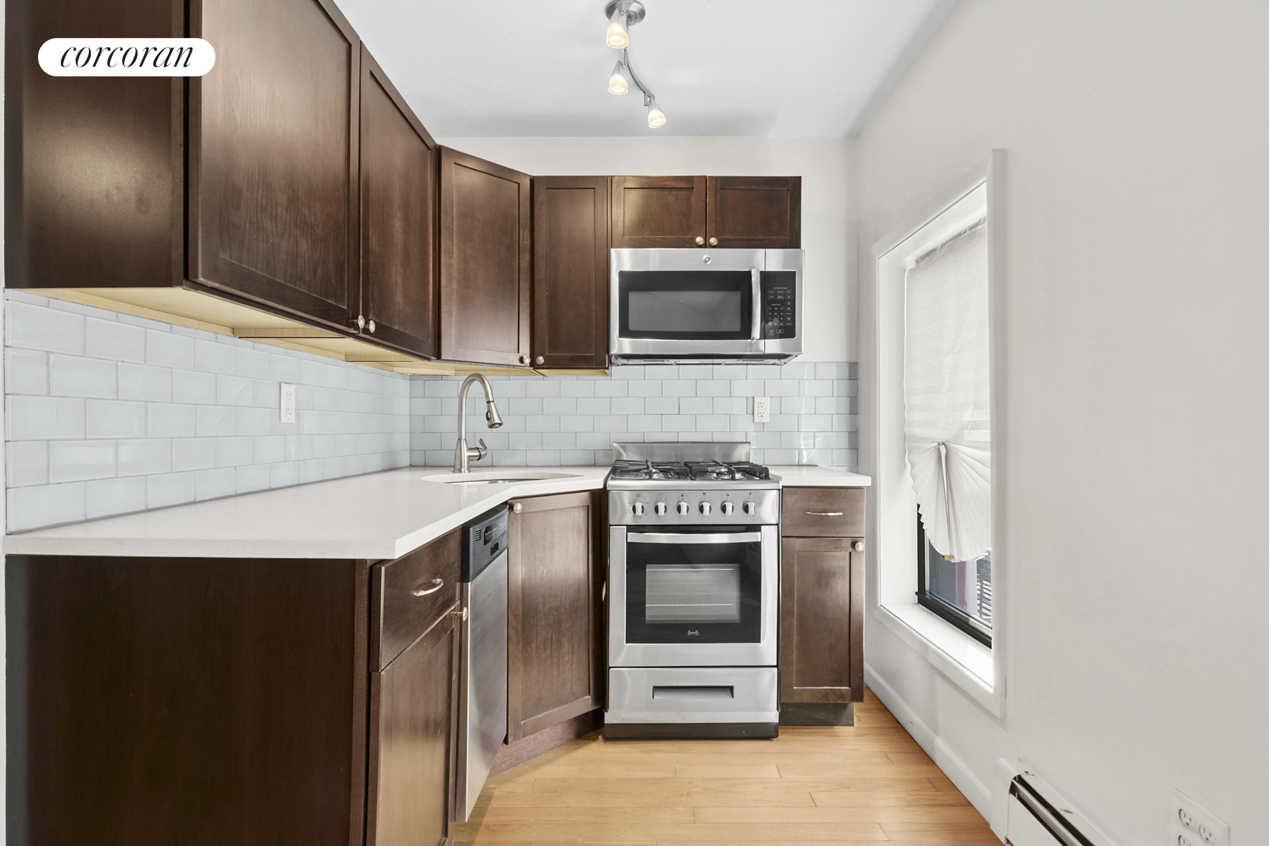 178 Sackett Street Brooklyn, NY 10017 - Photo 7 of 13 a kitchen with stainless steel appliances granite countertop a stove microwave and refrigerator
