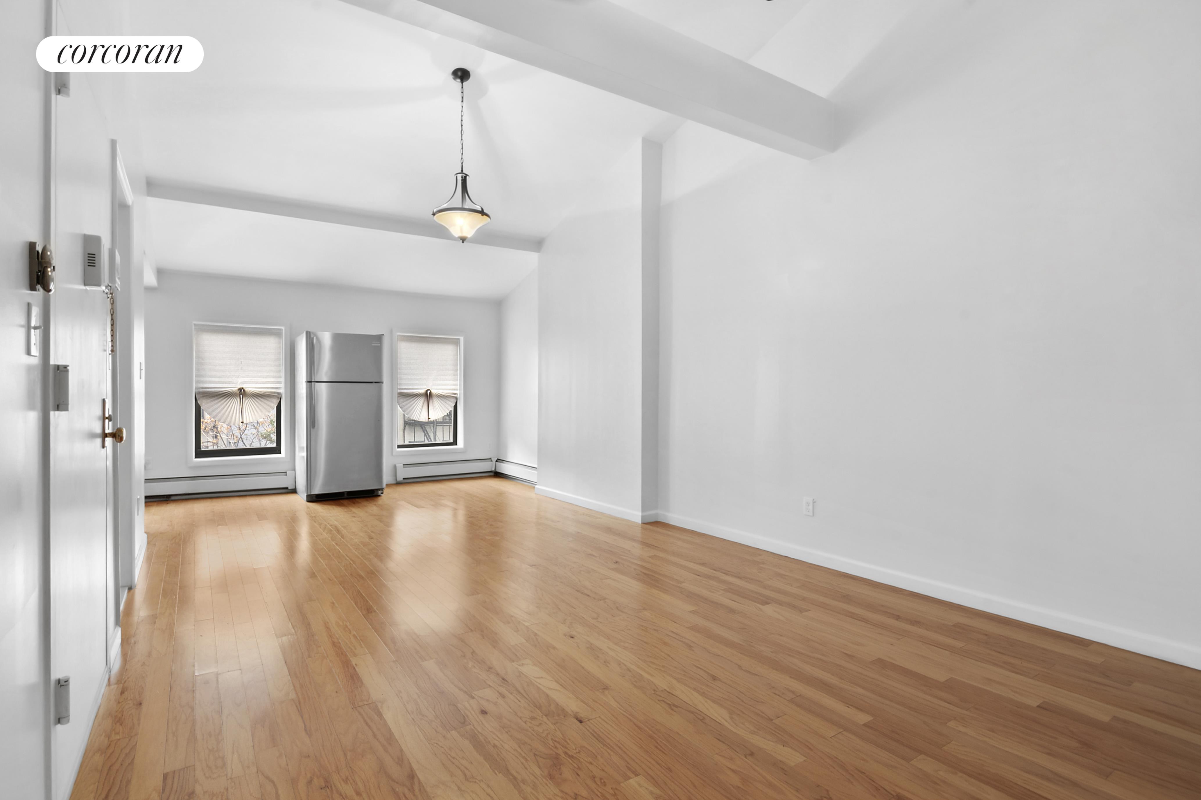 178 Sackett Street Brooklyn, NY 10017 - Photo 8 of 13 a view of an empty room with window and wooden floor