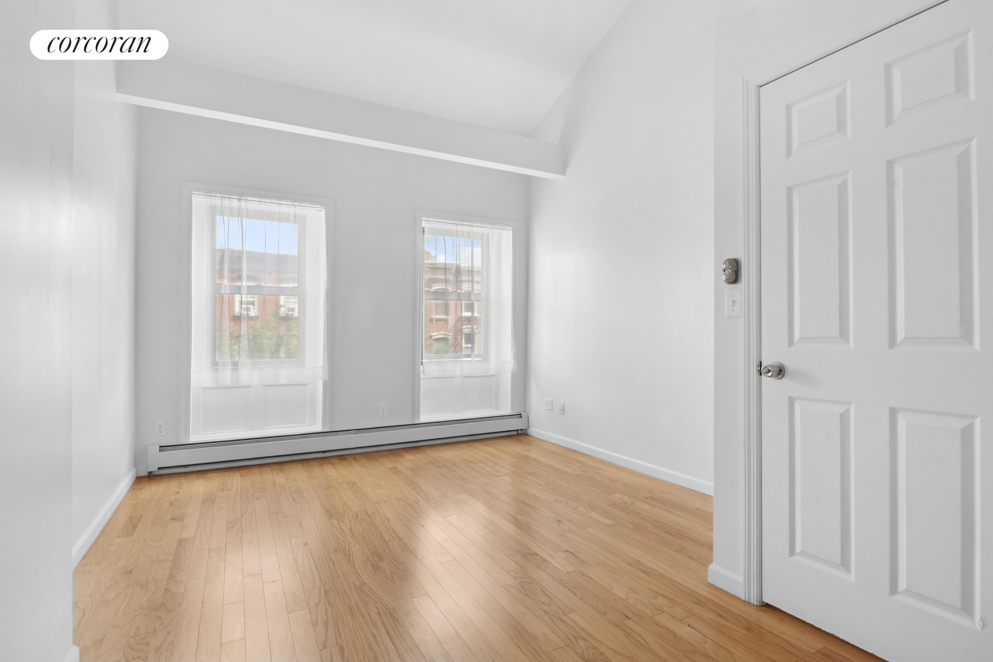 178 Sackett Street Brooklyn, NY 10017 - Photo 9 of 13 a view of an empty room with wooden floor and a window