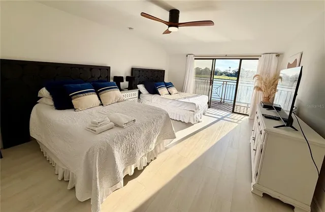 a large white bed in a white room