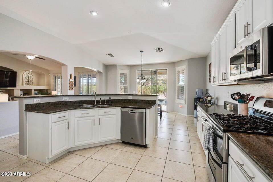 2624 West Summerside Road Phoenix, AZ 85041 - Photo 12 of 31 a kitchen with stainless steel appliances granite countertop a stove and a sink