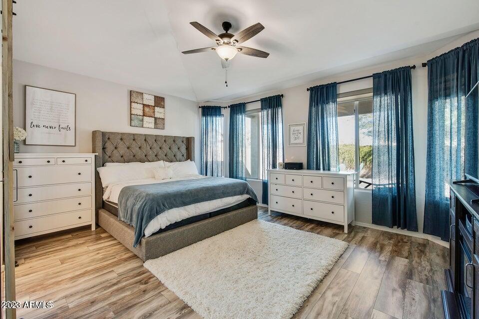 2624 West Summerside Road Phoenix, AZ 85041 - Photo 17 of 31 a bedroom with a large bed and a chandelier