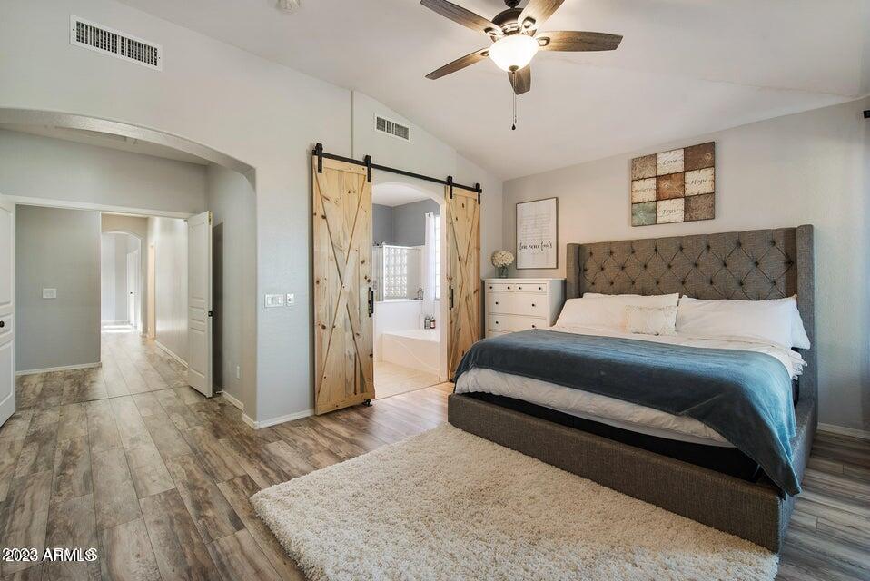 2624 West Summerside Road Phoenix, AZ 85041 - Photo 18 of 31 a bedroom with a bed and a chandelier