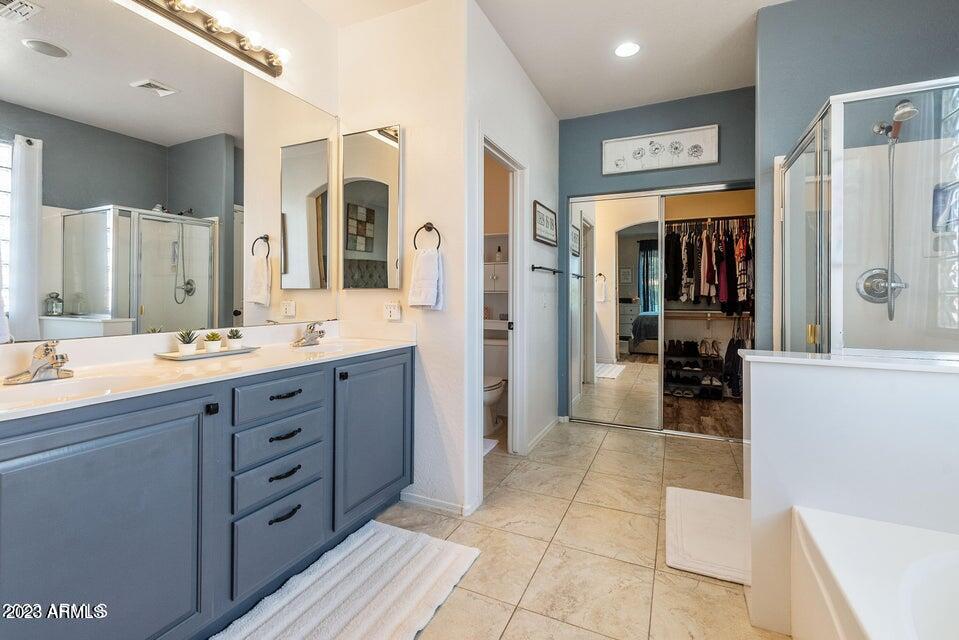 2624 West Summerside Road Phoenix, AZ 85041 - Photo 19 of 31 a bathroom with a sink mirror and shower