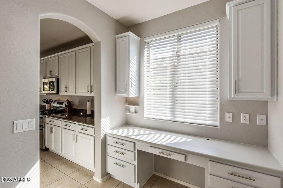 2624 West Summerside Road Phoenix, AZ 85041 - Photo 23 of 31 a kitchen with a stove and a white cabinet