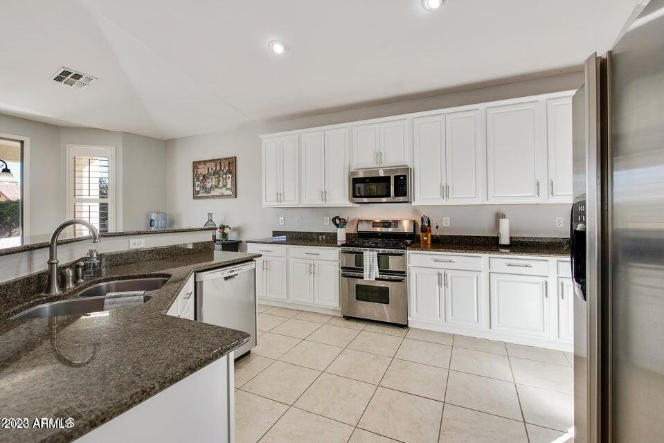2624 West Summerside Road Phoenix, AZ 85041 - Photo 8 of 31 a kitchen with kitchen island granite countertop a sink a counter top space appliances and cabinets