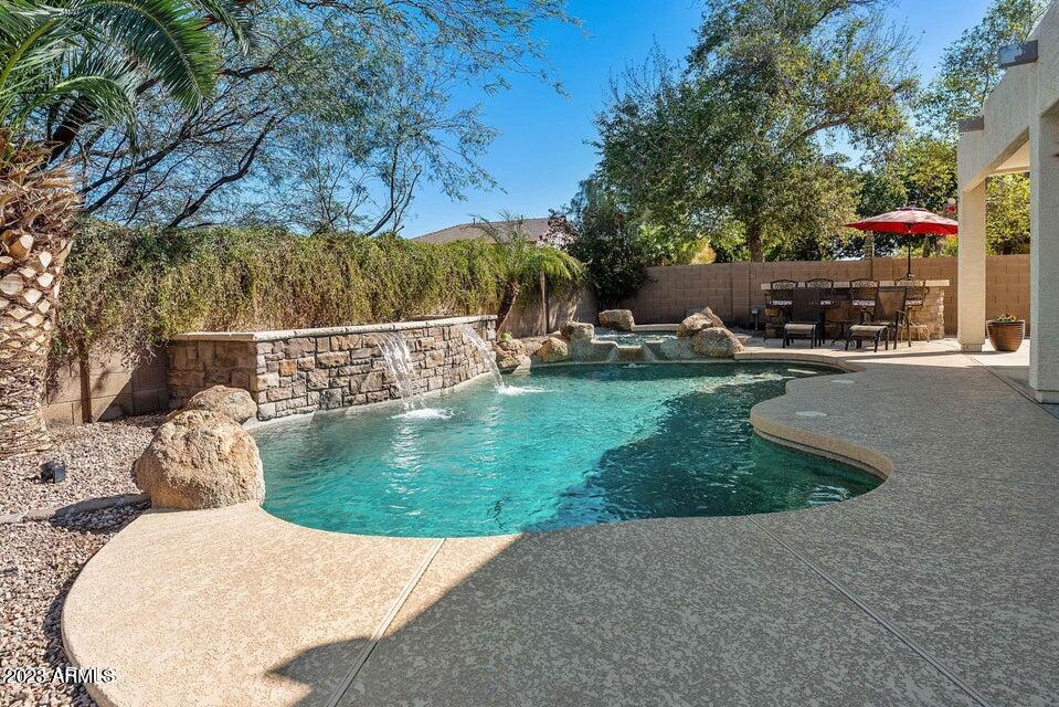 2624 West Summerside Road Phoenix, AZ 85041 - Photo 10 of 31 a view of a swimming pool with a patio