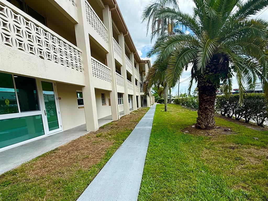 4455 Duhme Road, Unit 103 St. Petersburg, FL 33708 - Photo 5 of 37 a view of a house with a yard