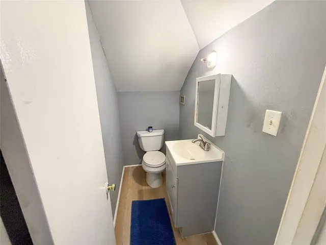 a bathroom with a sink toilet and mirror