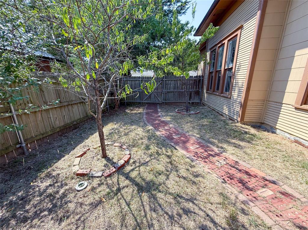1210 Monroe Street Commerce, TX 75428 - Photo 20 of 20 a view of a backyard with a tree