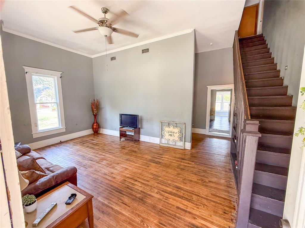 1210 Monroe Street Commerce, TX 75428 - Photo 3 of 20 a living room with furniture and a wooden floor