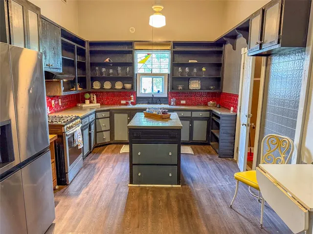 a kitchen view of wooden floor and electronic appliances
