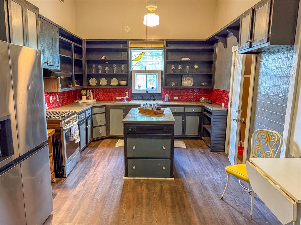 1210 Monroe Street Commerce, TX 75428 - Photo 5 of 20 a kitchen view of wooden floor and electronic appliances