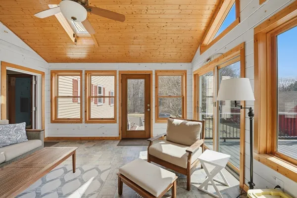 a living room with furniture and floor to ceiling windows