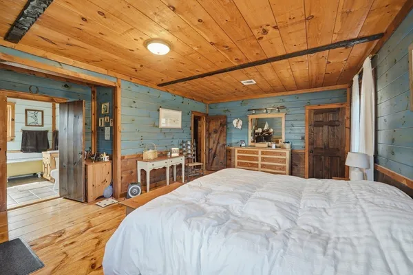 a bedroom with a large bed and a large window