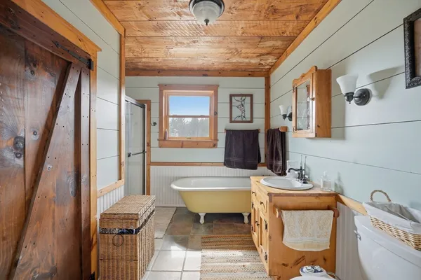 a bathroom with a sink mirror toilet and bathtub