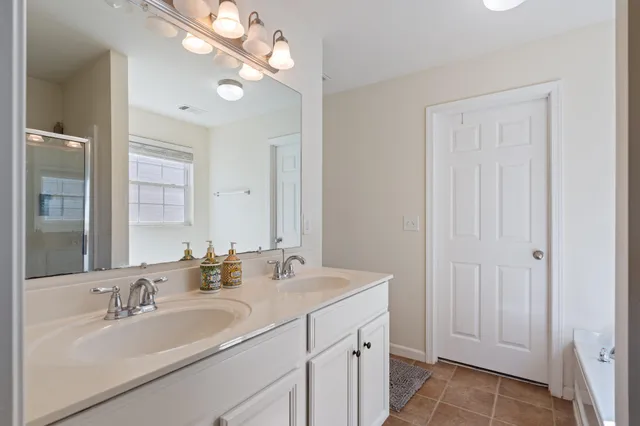 a bathroom with 2 sink and a mirror