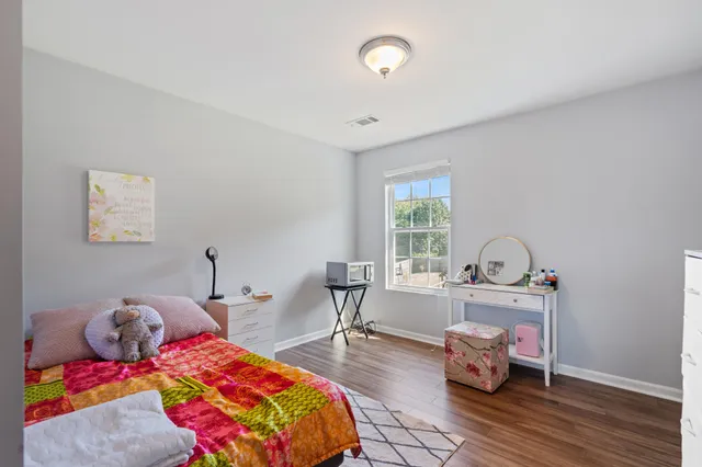 a bedroom with bed and a window