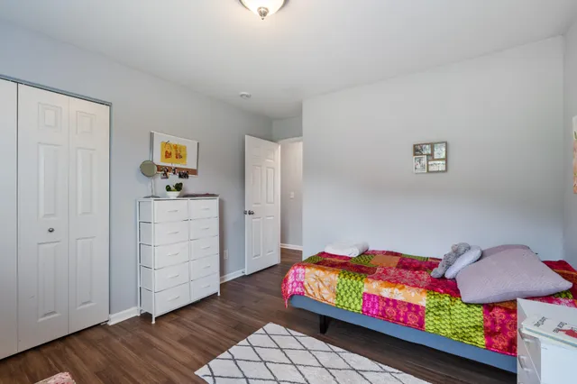 a bedroom with furniture and wooden floor