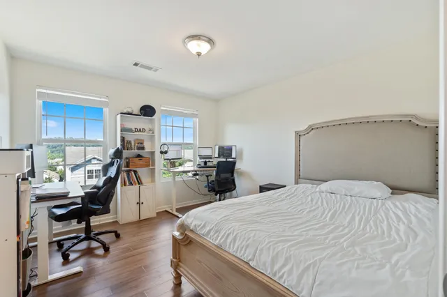 a bedroom with a bed a desk and chair