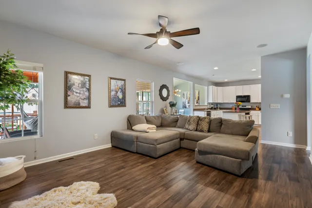 a living room with furniture and a wooden floor