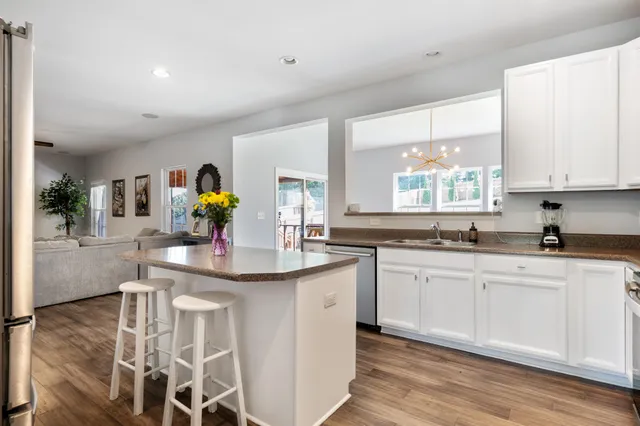 a kitchen with stainless steel appliances granite countertop a sink and cabinets