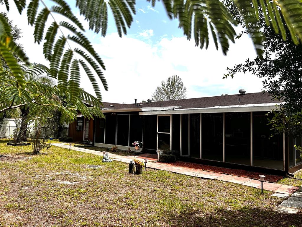 14545 Southwest 34th Terrace Road Ocala, FL 34473 - Photo 32 of 33 Screened-in backyard porch.