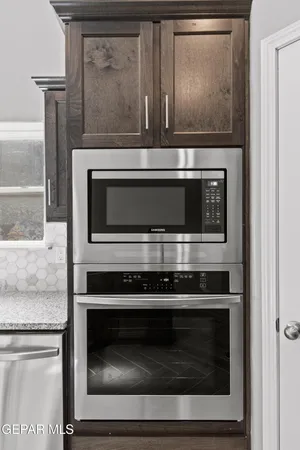 a stove top oven sitting inside of a kitchen