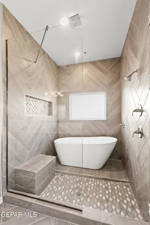 a bathroom with a bathtub and shower