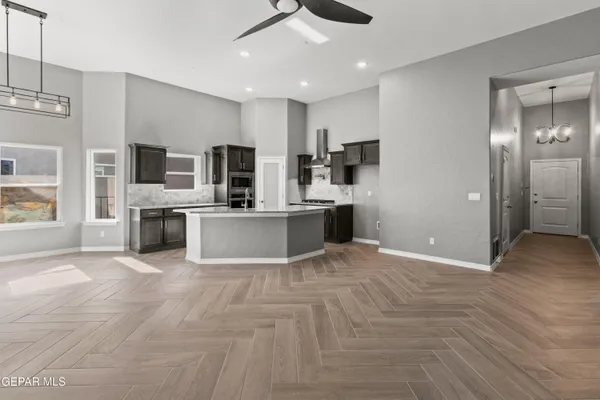 a view of a kitchen with a sink cabinets and stainless steel appliances