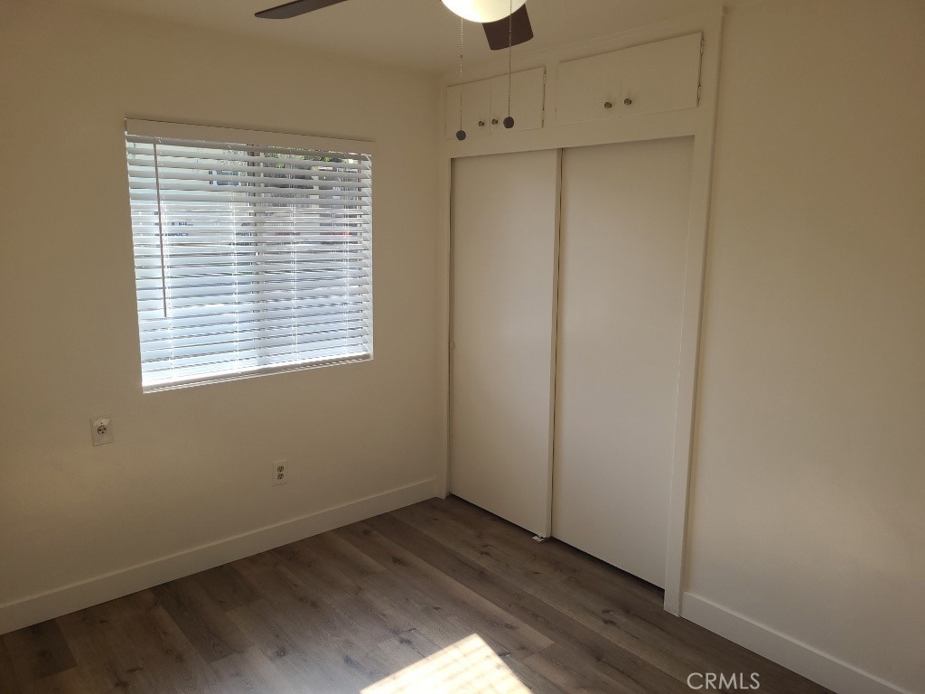 6262 Jones Riverside, CA 92505 - Photo 3 of 6 a view of an empty room with wooden floor and a window
