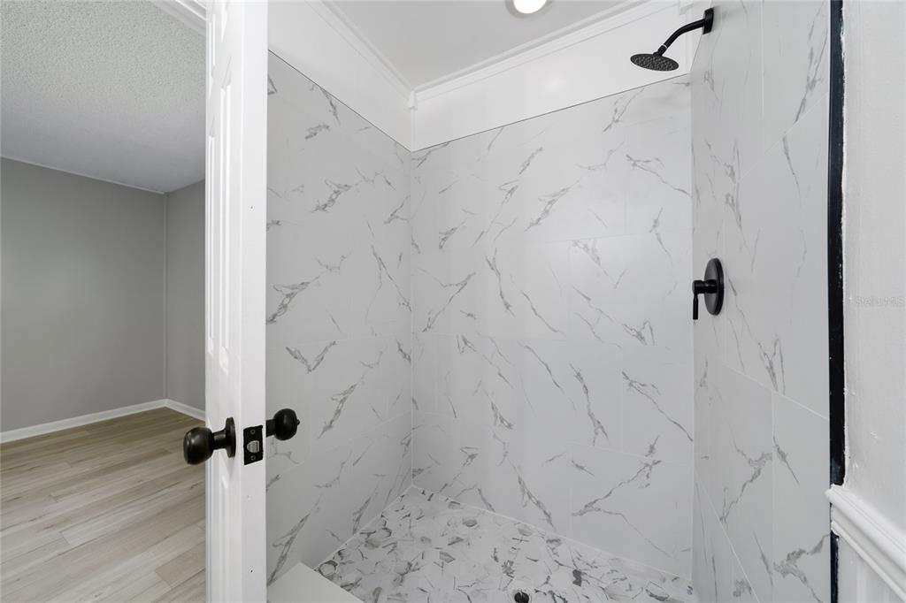 1034 Falcon Street Deltona, FL 32725 - Photo 19 of 36 a bathroom with a shower