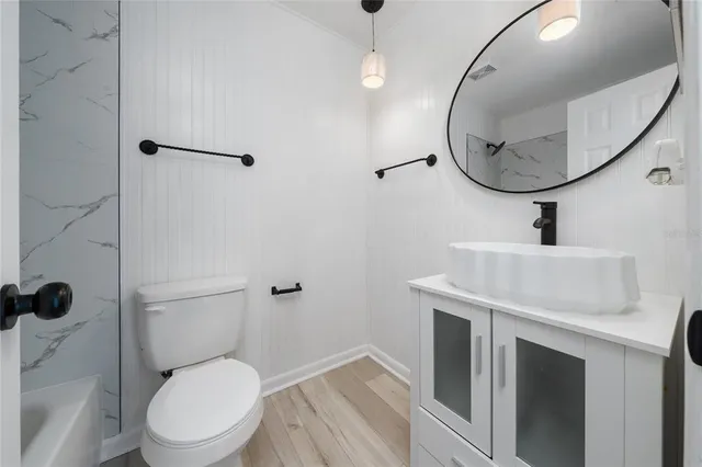 a bathroom with a toilet a sink and a mirror