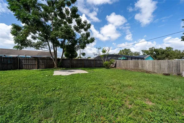 a view of yard with swimming pool and green space