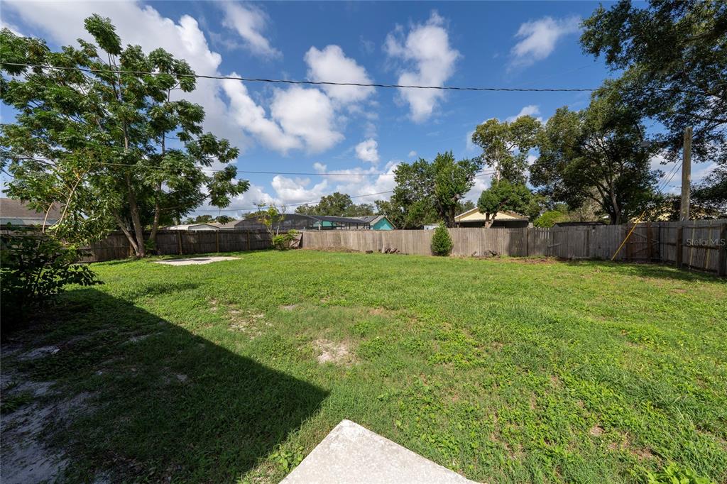 1034 Falcon Street Deltona, FL 32725 - Photo 30 of 36 a view of a backyard with a garden
