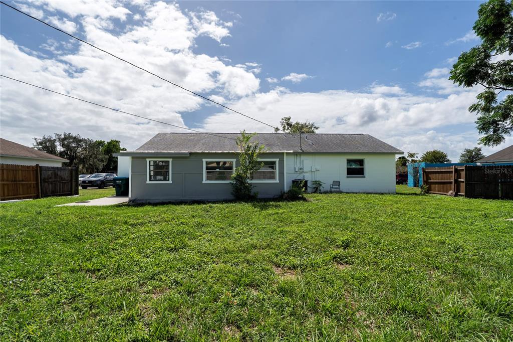 1034 Falcon Street Deltona, FL 32725 - Photo 31 of 36 a front view of a house with a garden