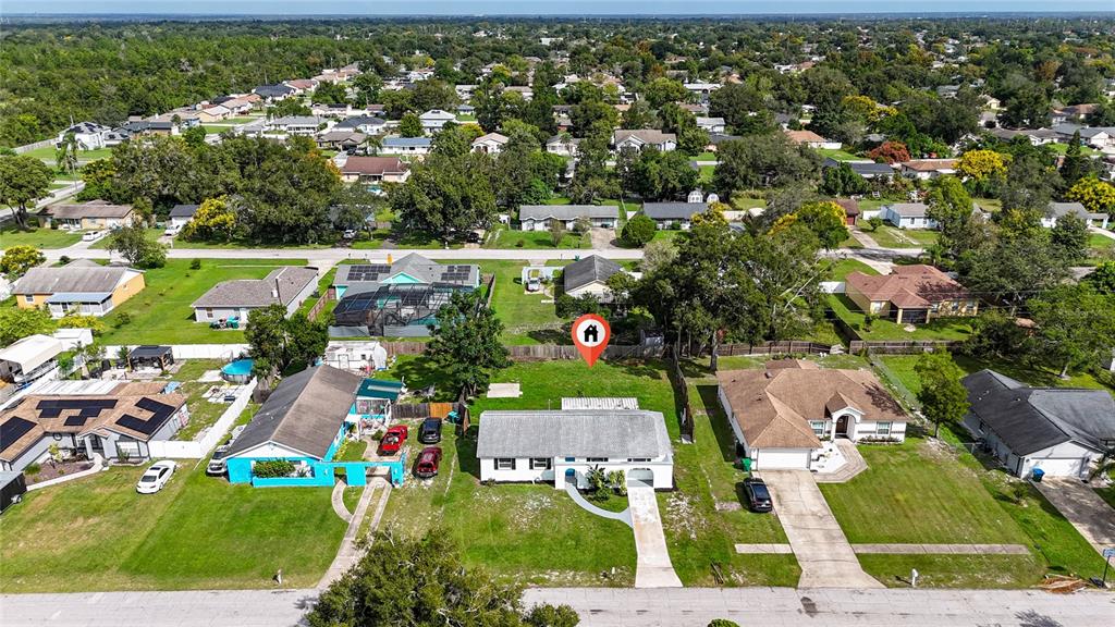 1034 Falcon Street Deltona, FL 32725 - Photo 33 of 36 an aerial view of residential houses with outdoor space and street view