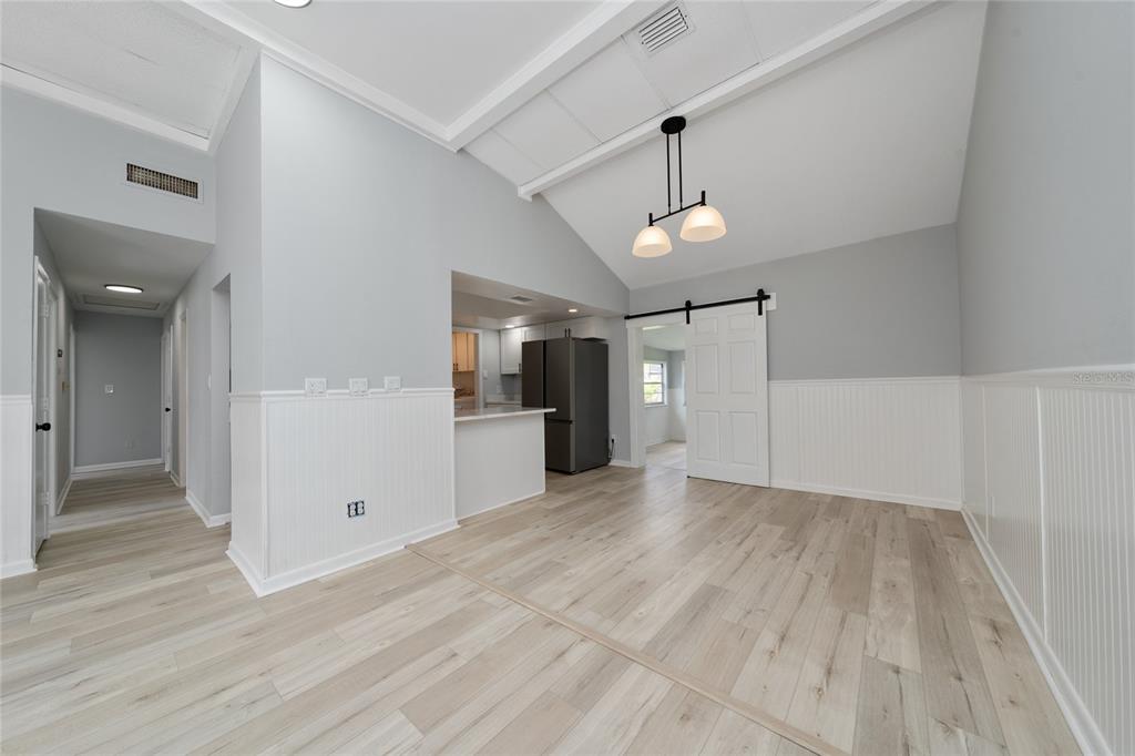 1034 Falcon Street Deltona, FL 32725 - Photo 10 of 36 wooden floor in an empty room with a window