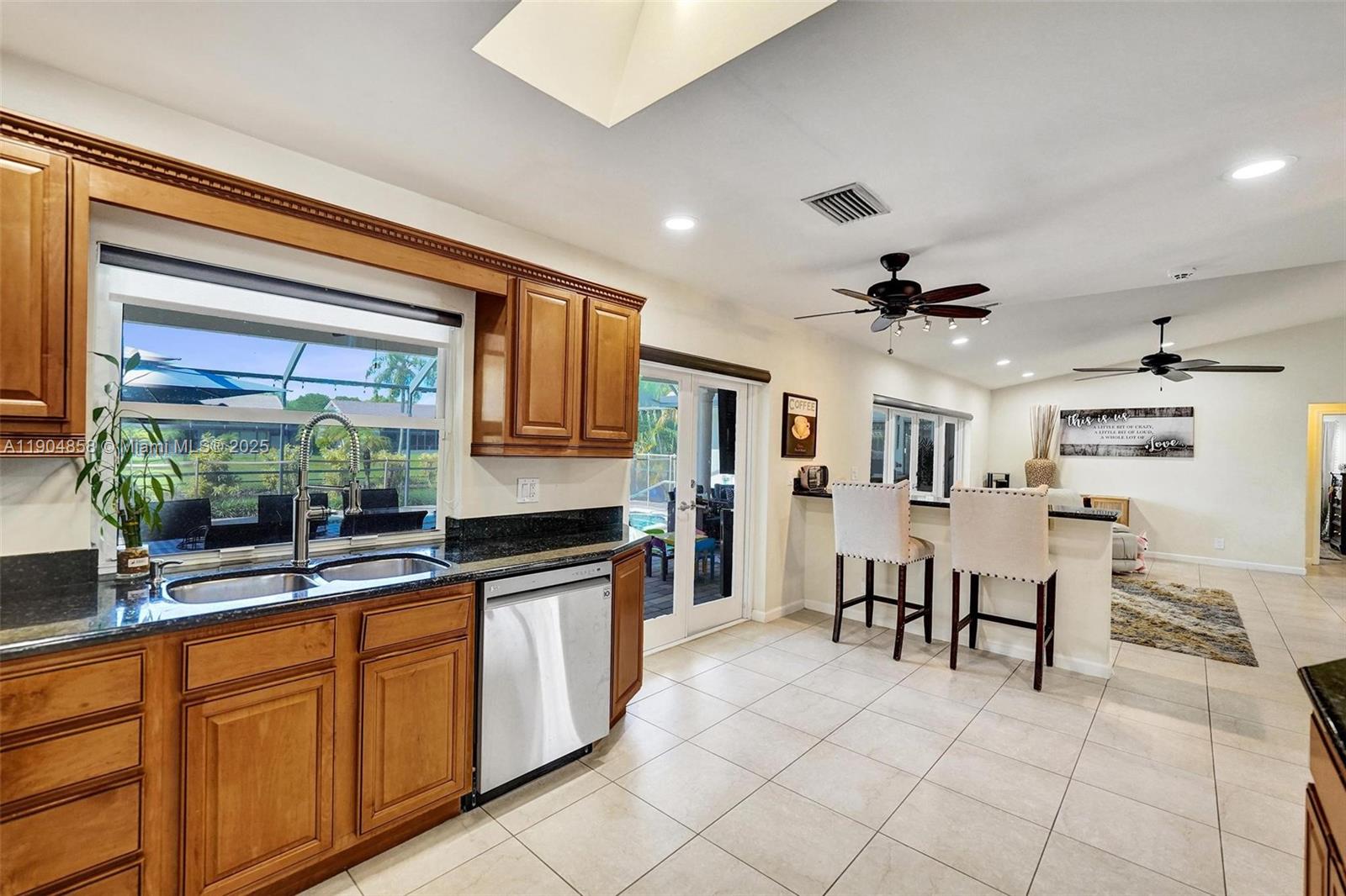 1501 Northwest 99th Avenue Plantation, FL 33322 - Photo 14 of 45 a open kitchen with stainless steel appliances granite countertop a refrigerator and a sink