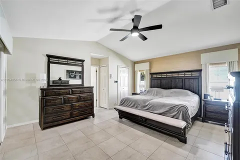 a bedroom with a bed and ceiling fan