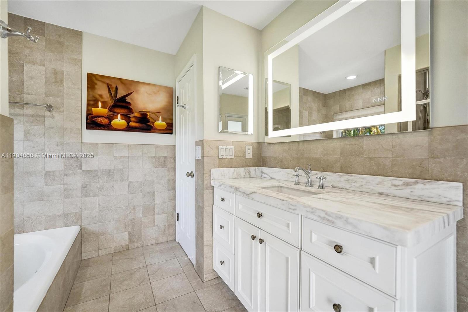 1501 Northwest 99th Avenue Plantation, FL 33322 - Photo 20 of 45 a bathroom with a sink a vanity a mirror and a shower