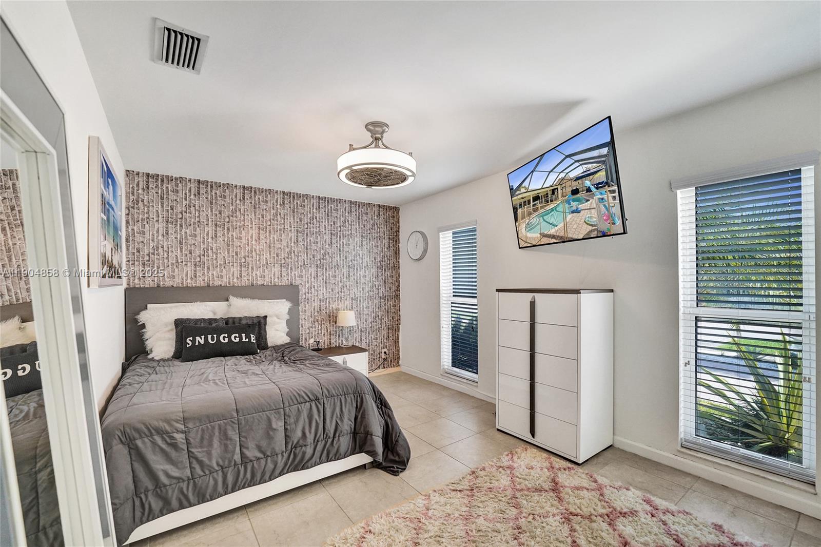 1501 Northwest 99th Avenue Plantation, FL 33322 - Photo 25 of 45 a bedroom with a bed and a painting on the wall