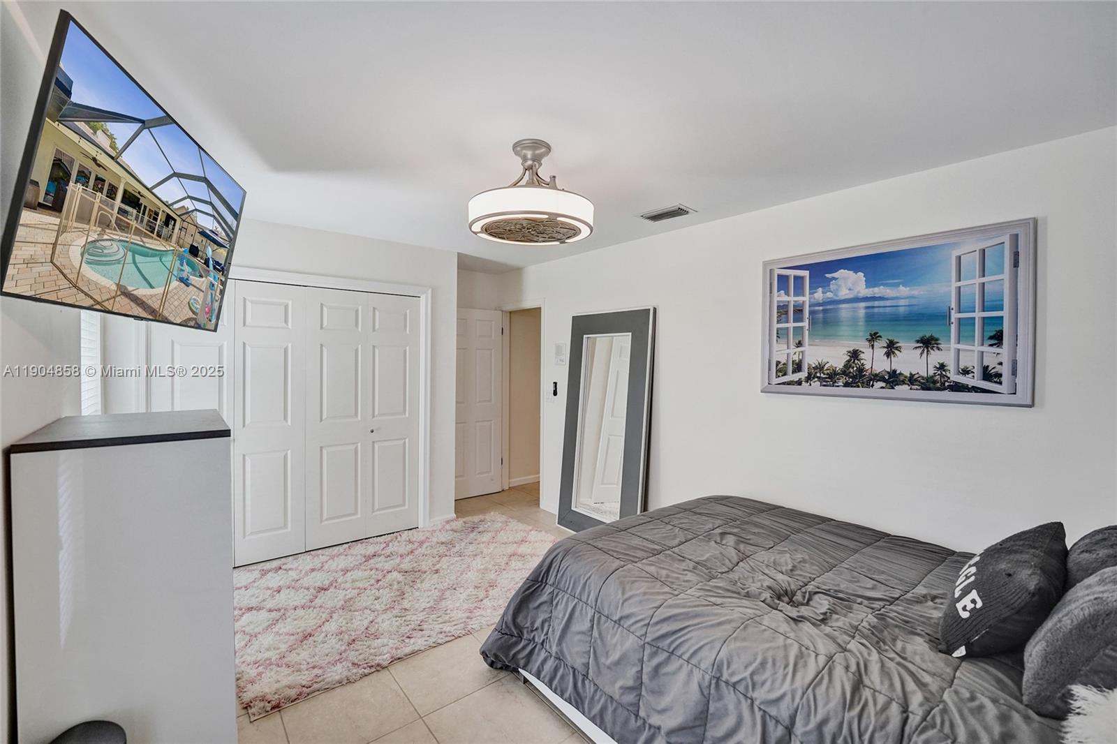 1501 Northwest 99th Avenue Plantation, FL 33322 - Photo 26 of 45 a bedroom with a bed and a painting on the wall