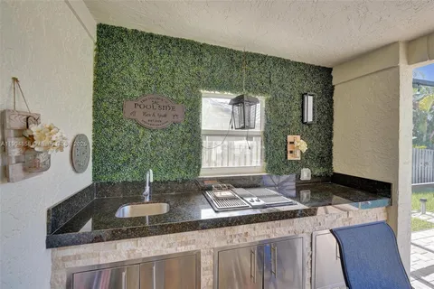 a kitchen with a sink and a stove top oven