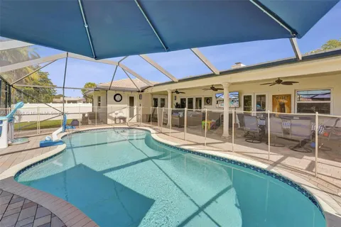 a view of a patio with chairs under an umbrella