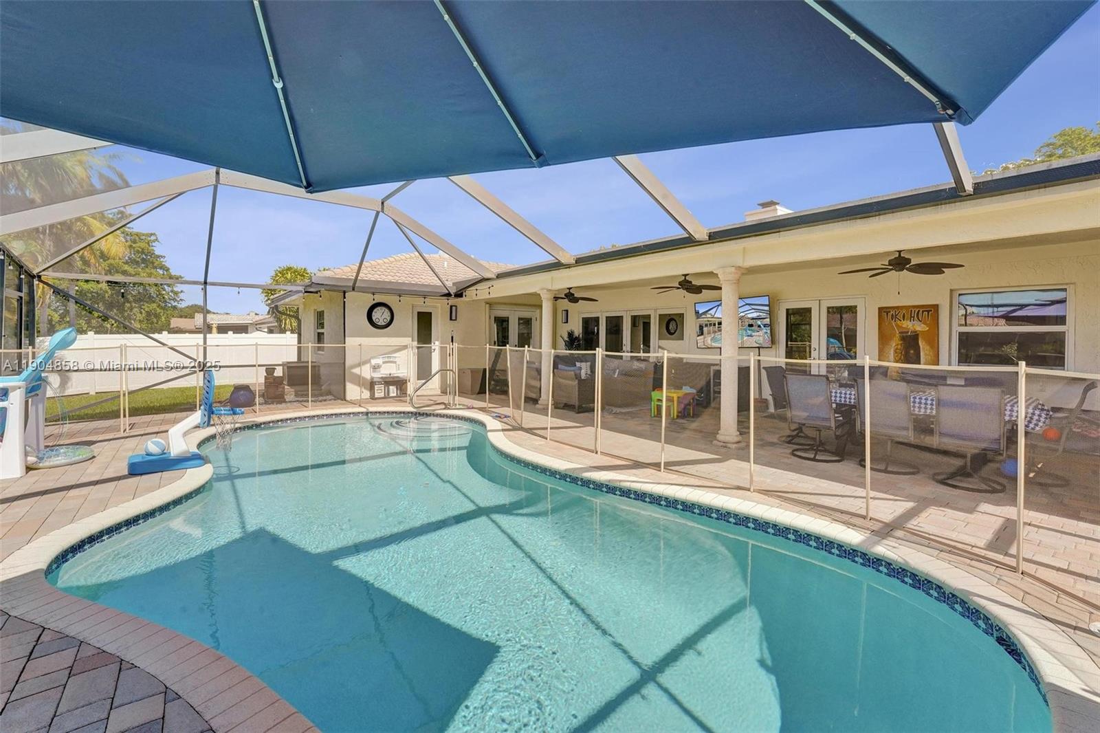 1501 Northwest 99th Avenue Plantation, FL 33322 - Photo 37 of 45 a view of a patio with chairs under an umbrella
