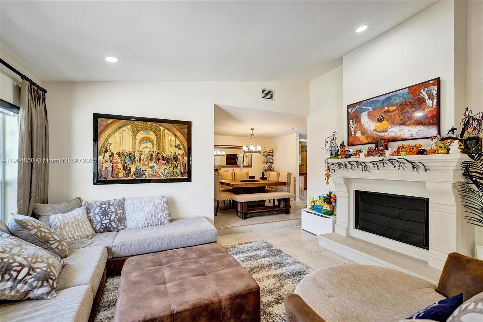 1501 Northwest 99th Avenue Plantation, FL 33322 - Photo 5 of 45 a living room with furniture a fireplace and a flat screen tv