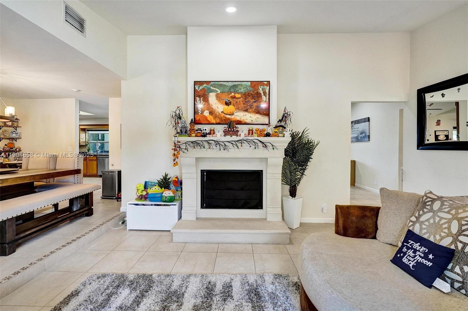 1501 Northwest 99th Avenue Plantation, FL 33322 - Photo 6 of 45 a living room with furniture a flat screen tv and a fireplace
