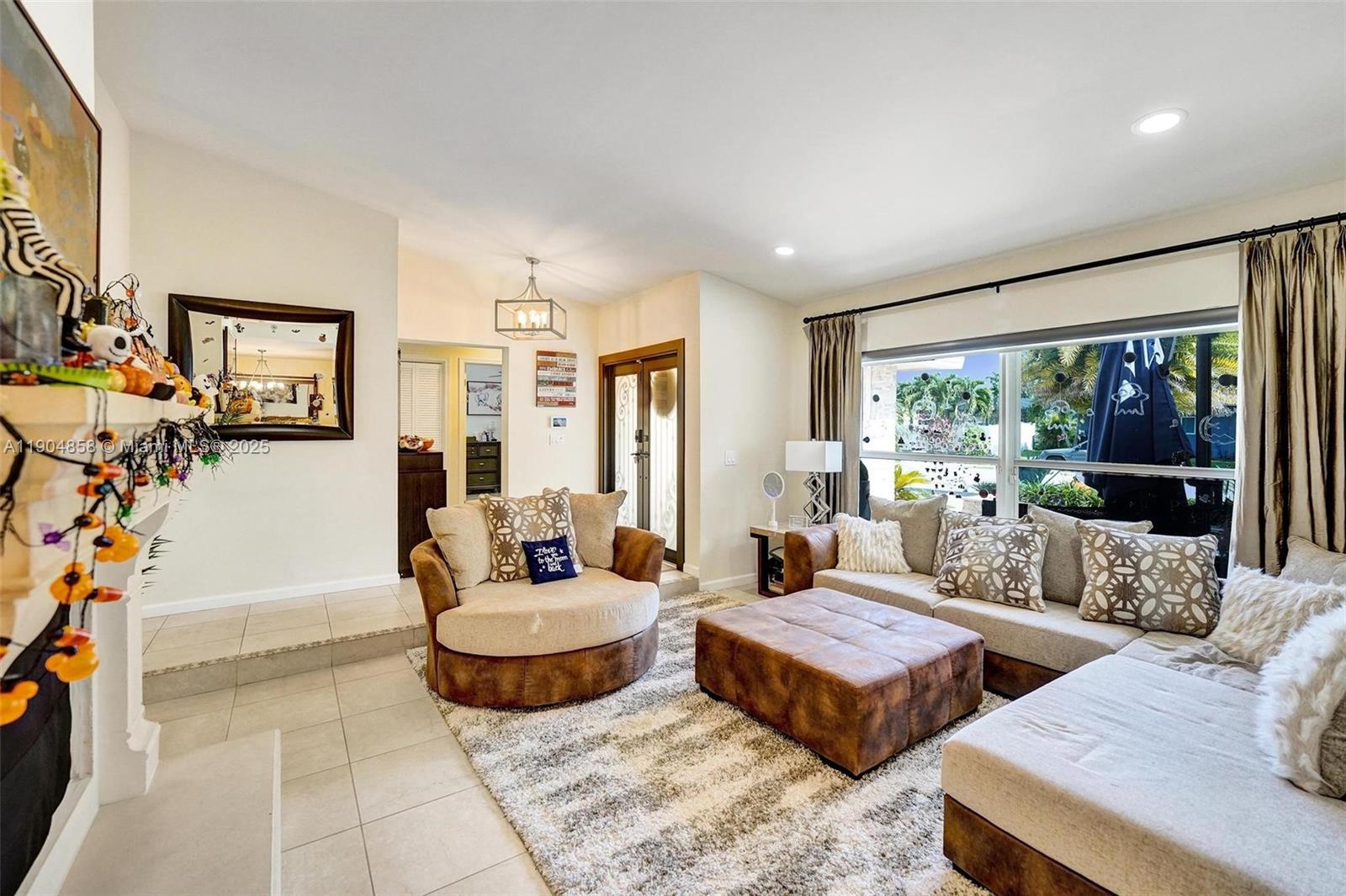 1501 Northwest 99th Avenue Plantation, FL 33322 - Photo 7 of 45 a living room with furniture and a floor to ceiling window